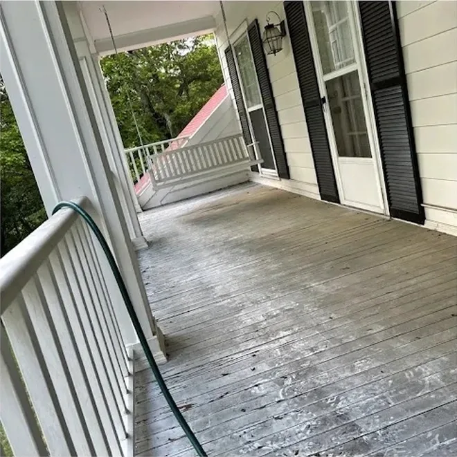 Worn porch floor boards before refinishing in Nashville TN